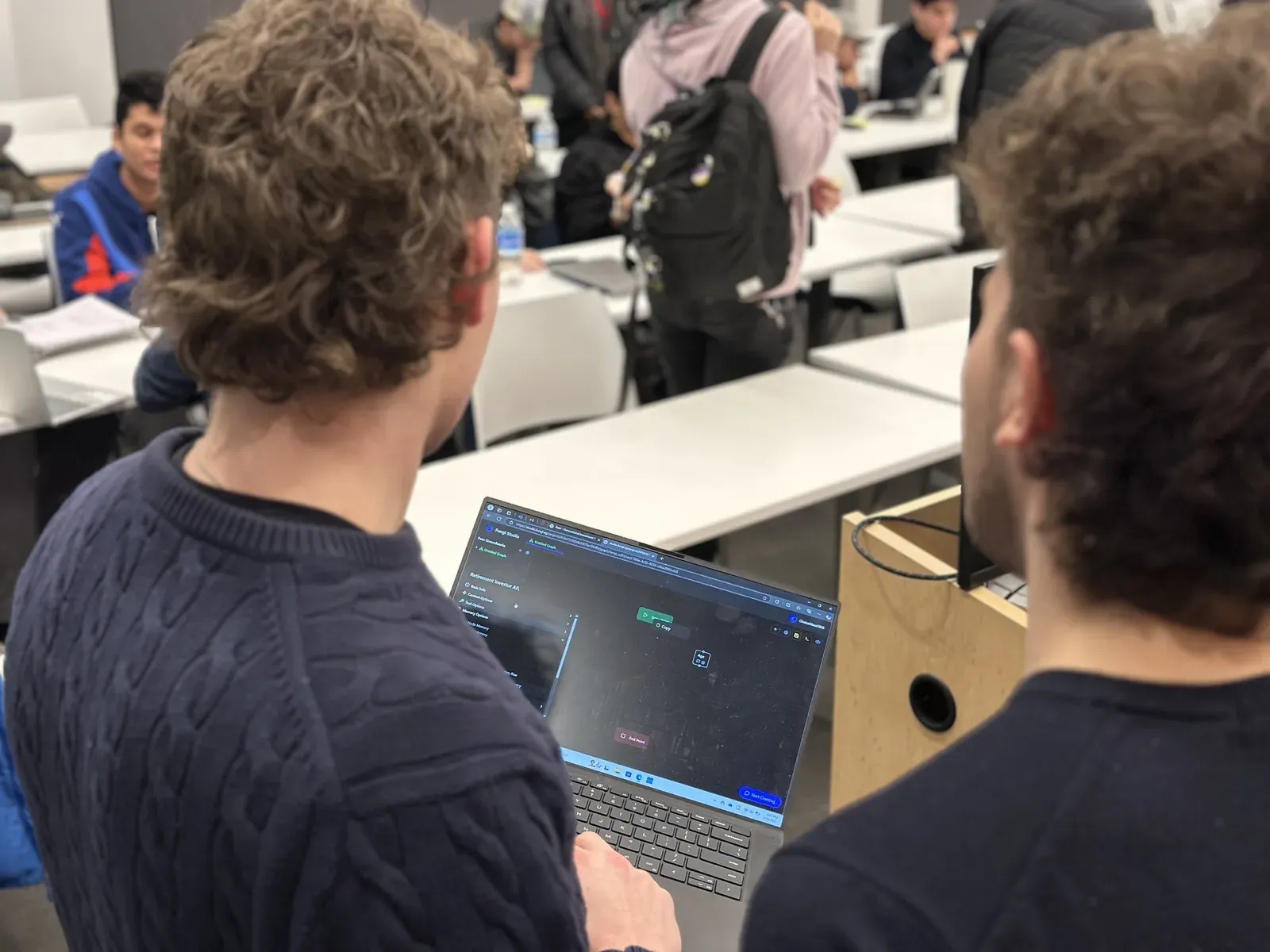 Samuel Schmitt working with students during a Sail hackathon session
